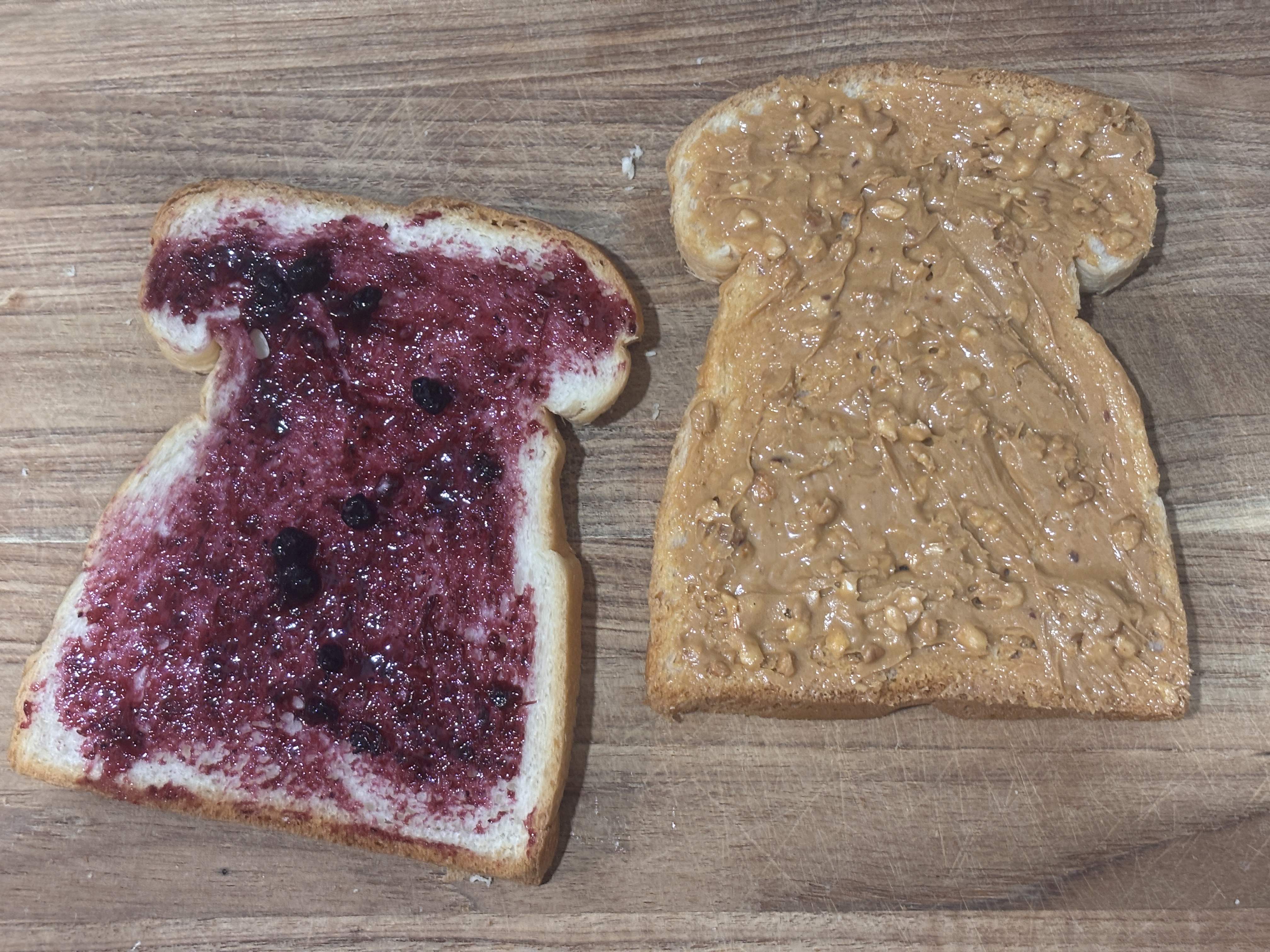 Peanut butter and jelly spread on two slices of bread